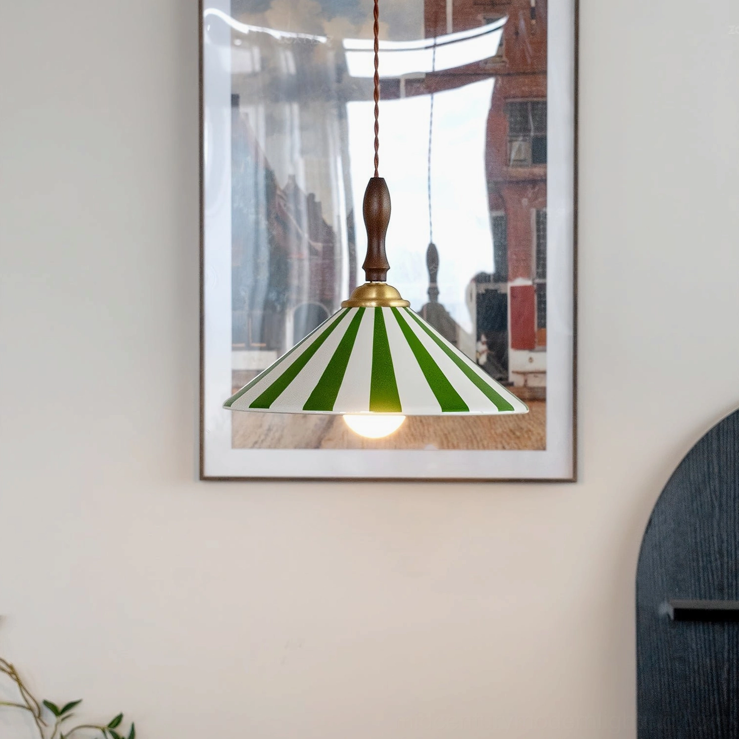 Green and white striped Bobine pendant light hanging from braided cord, exposed vintage bulb, living room interior styling