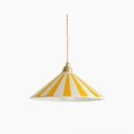 Bobine striped cone pendant light with yellow and white stripes, polished brass fixture, twisted cord, studio view
