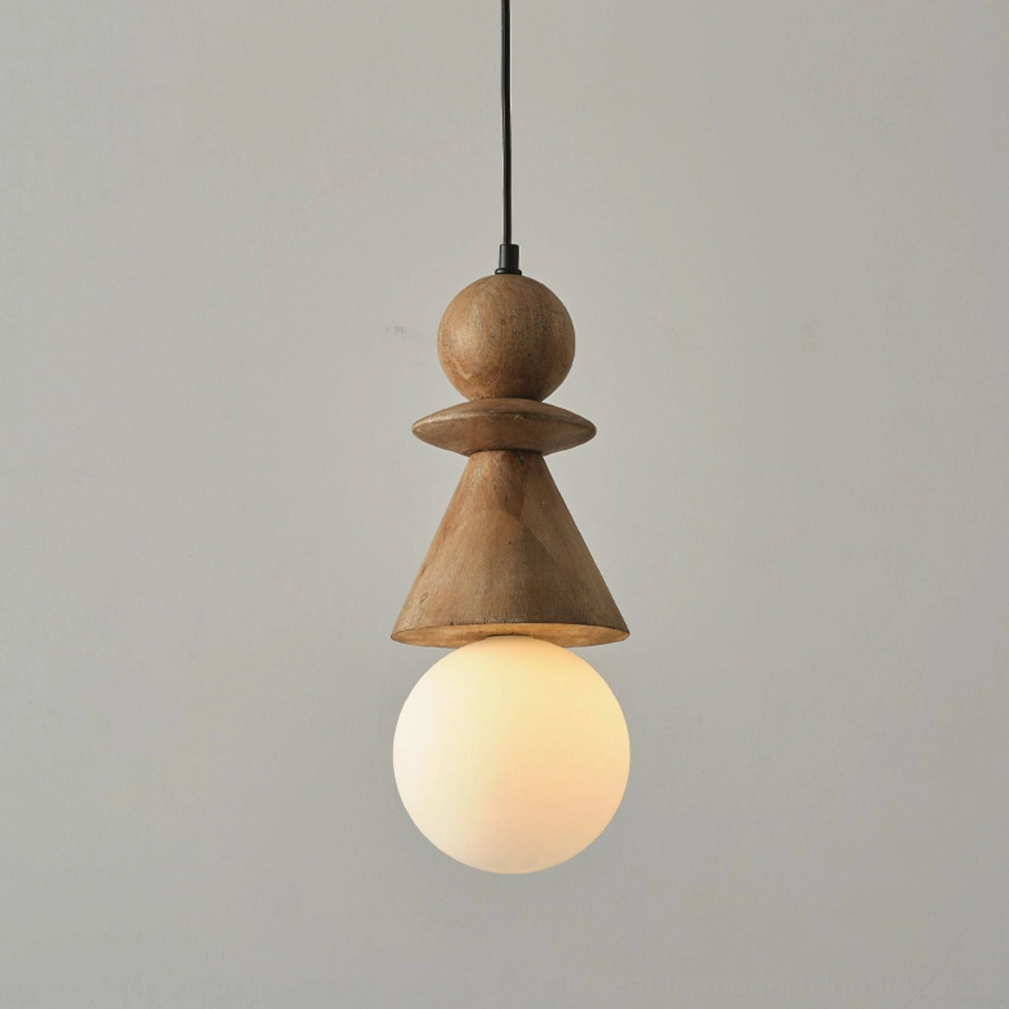 Illuminated Bodie stacked wood totem pendant light showing warm LED glow against neutral wall background, close-up detail view