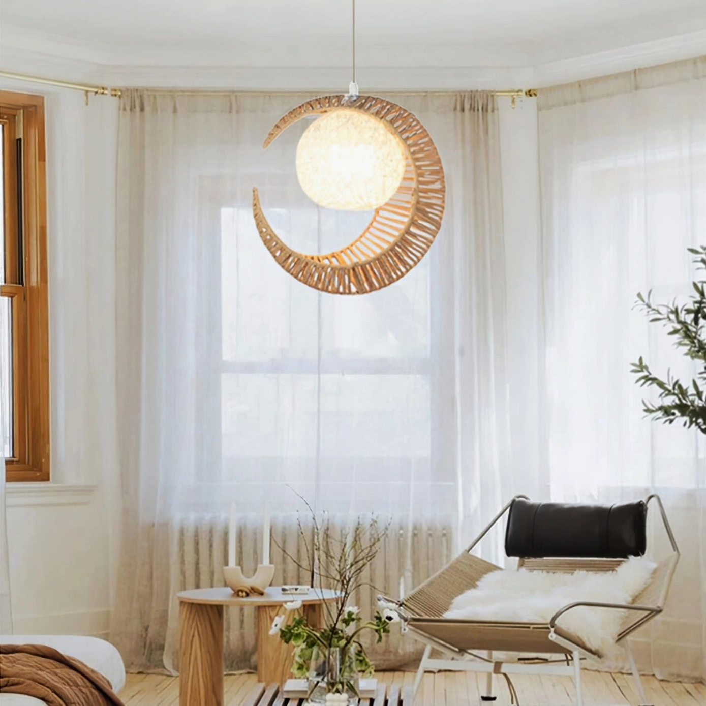 Bohemian moon pendant light hanging in Japanese minimalist living room with sheer curtains and beige hemp rope weave