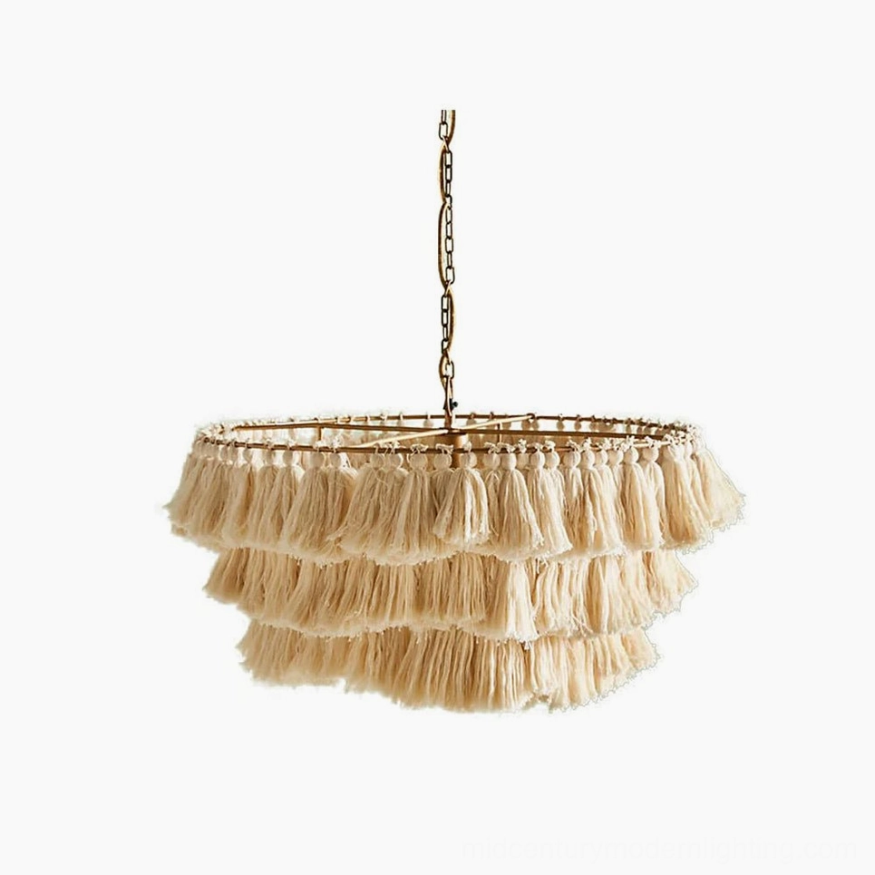 Cream layered tassel chandelier with handcrafted fabric tassels and metal frame on white studio background