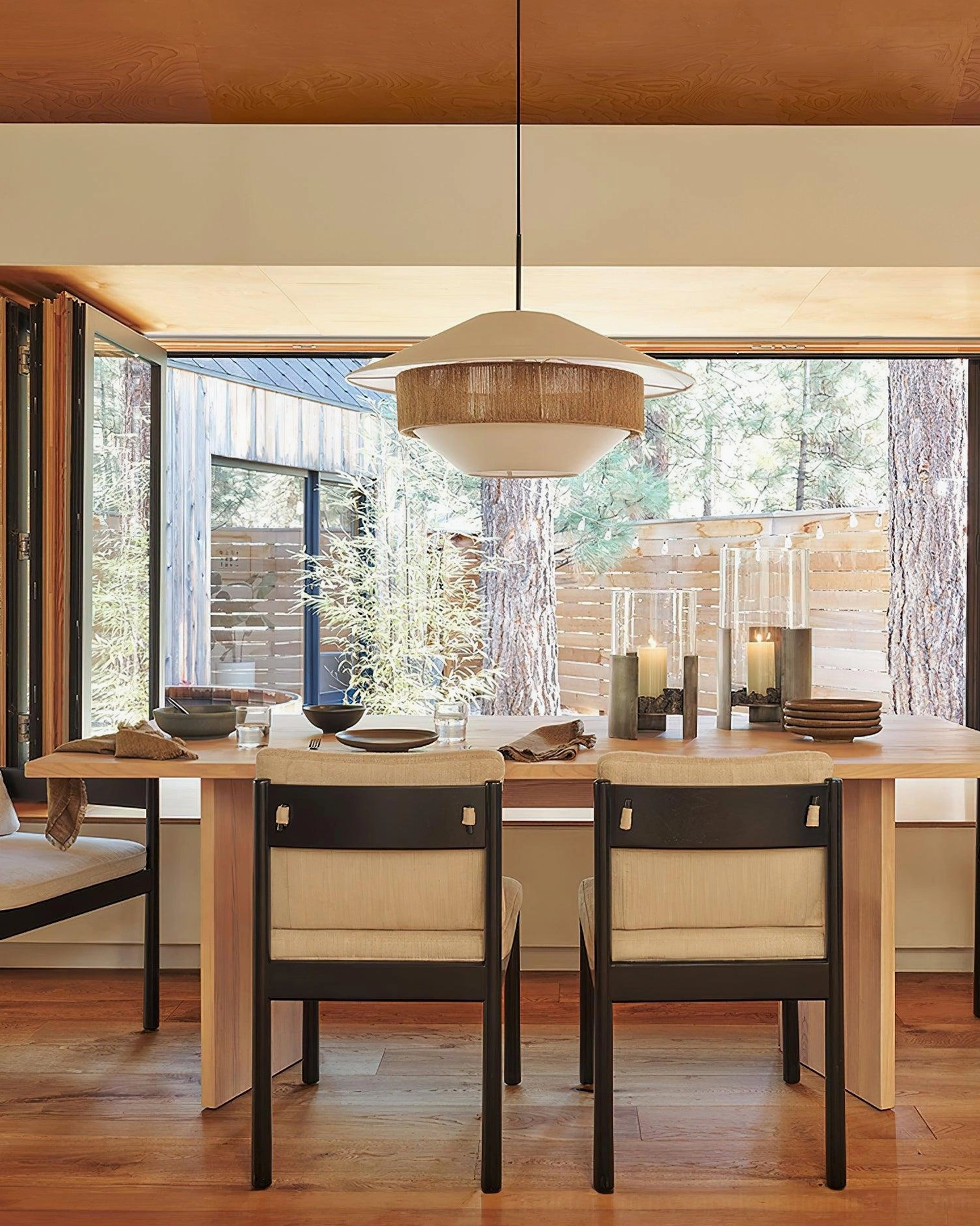 Clean warm bohemian woven pendant light in neatly arranged wooden dining setup