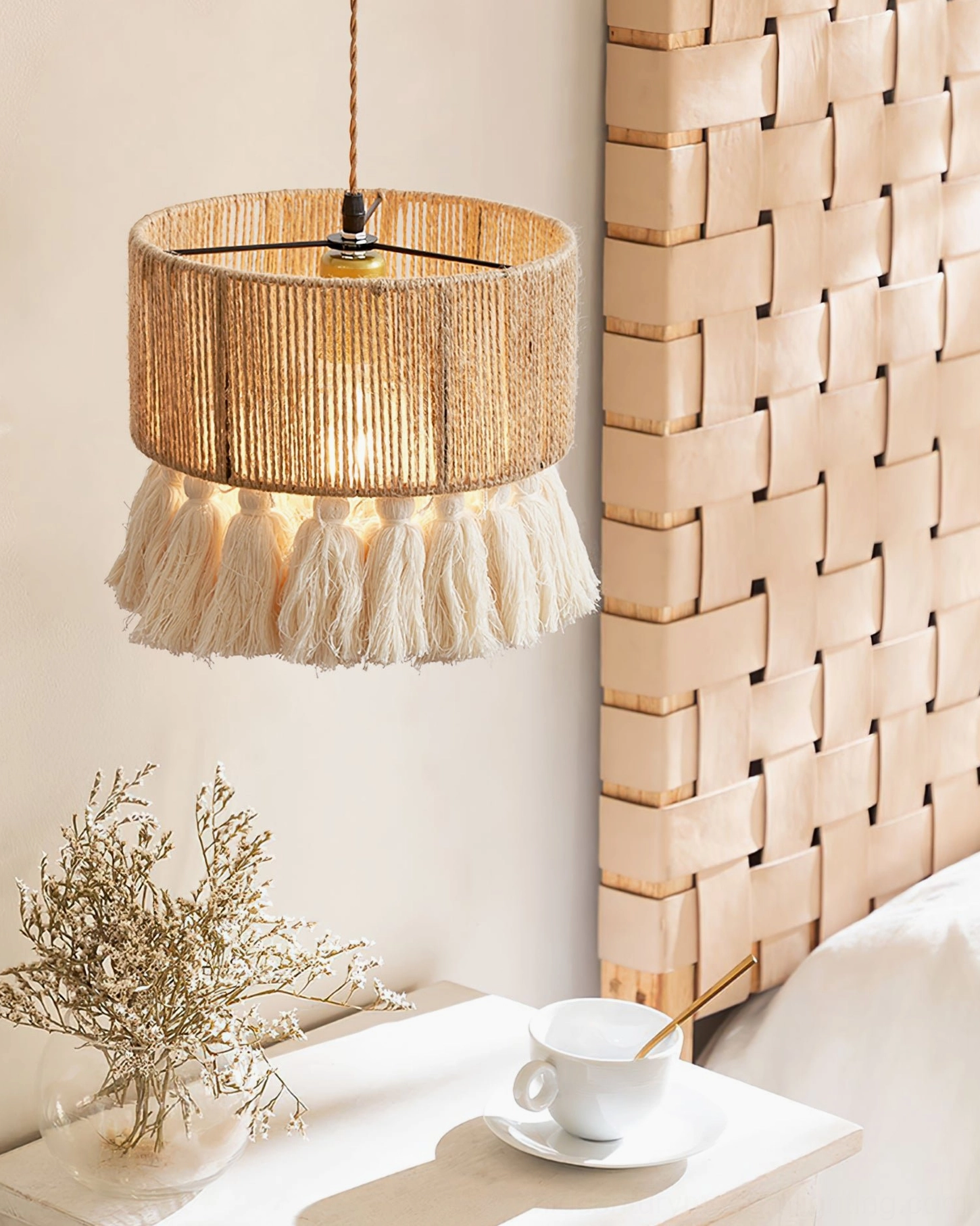 Bohemian tassel pendant light in bedroom corner with woven wall art, fluffy cotton tassels and natural hemp shade