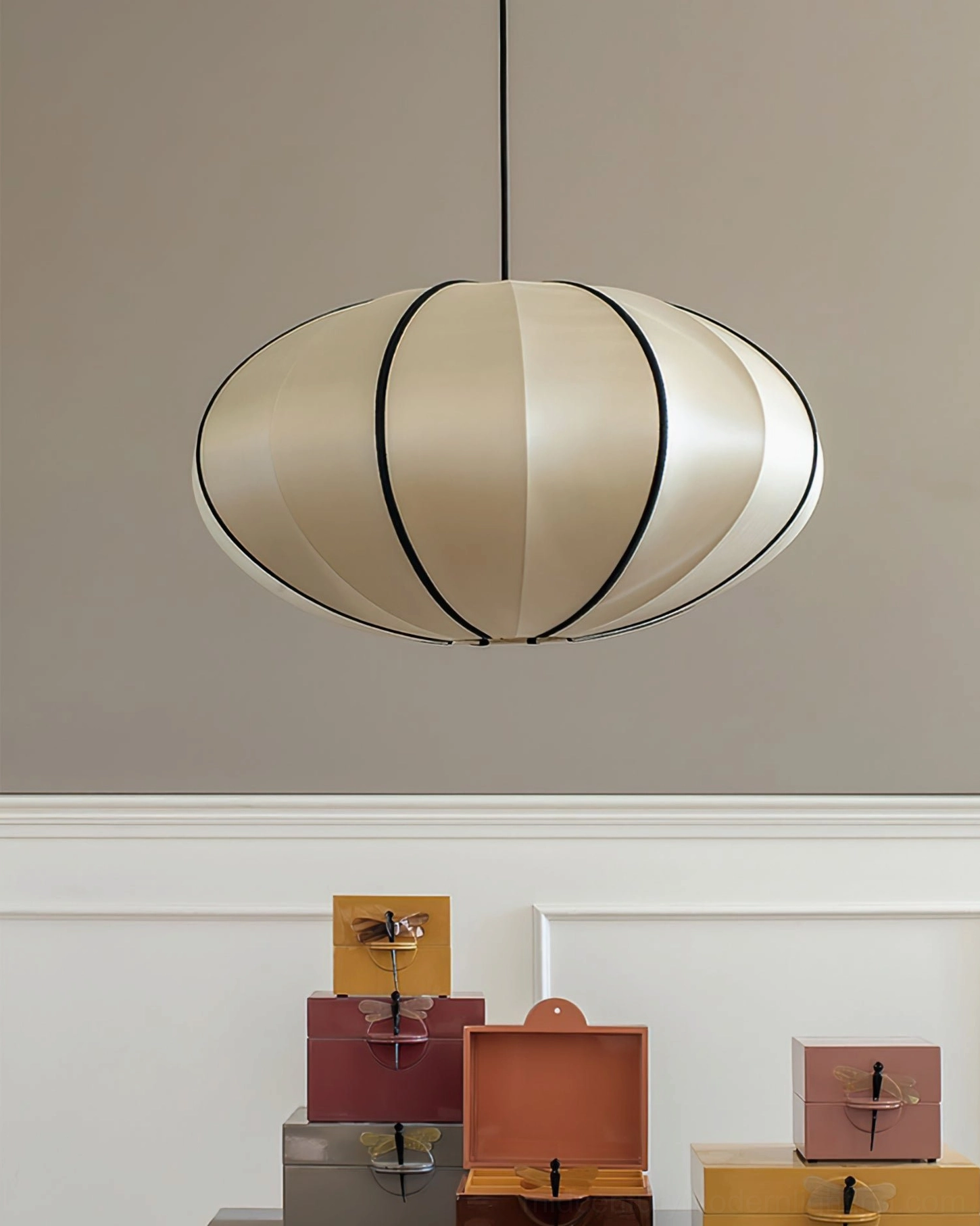 Single Bombori fabric pendant light with black trim, hanging display with wainscoting
