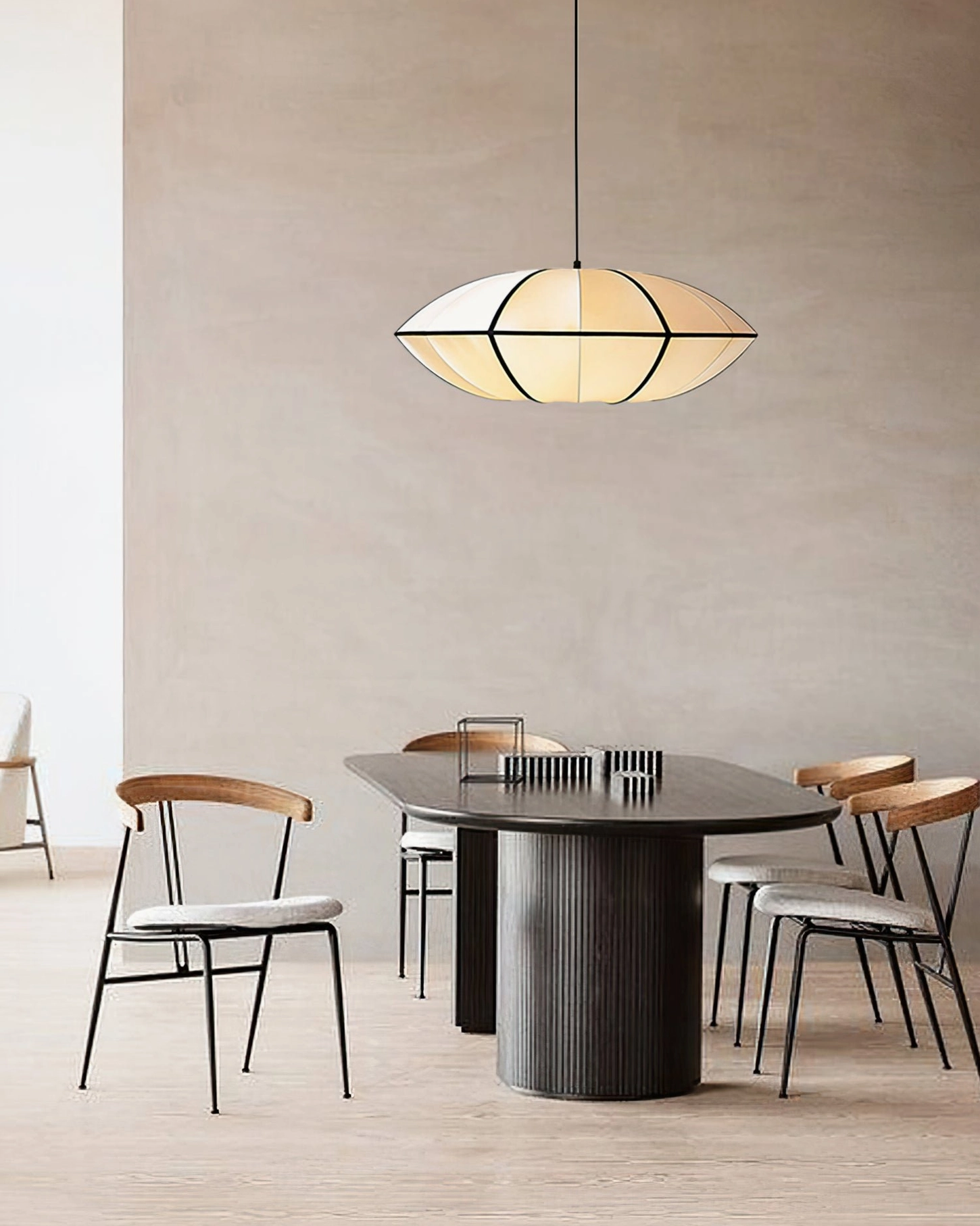 Bombori fabric pendant over dark oval dining table, warm neutral minimalist space