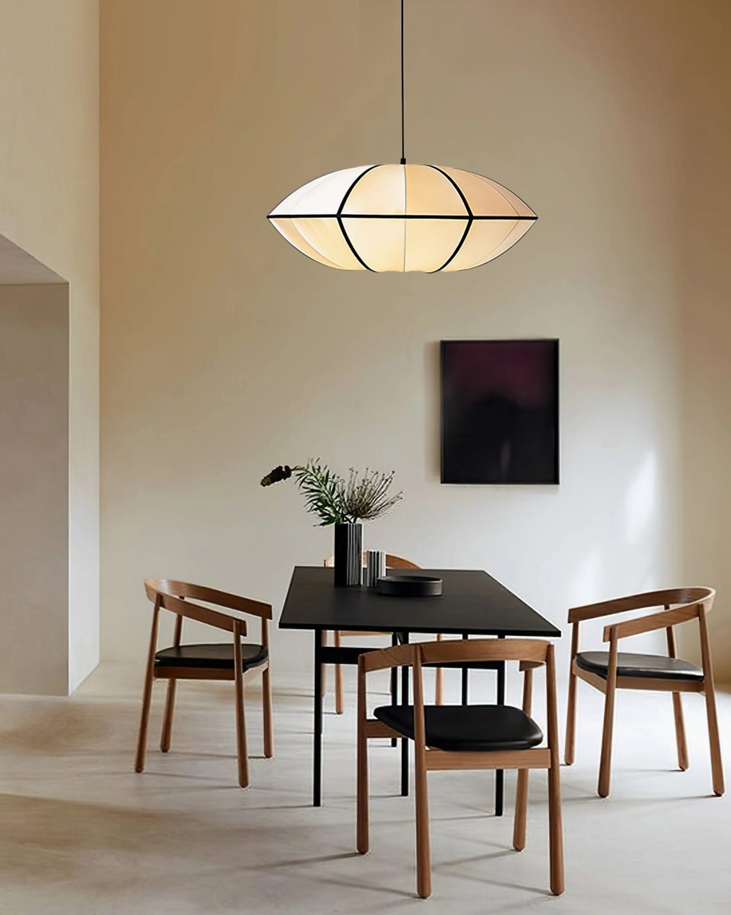Bombori pendant light above black dining table in modern minimalist dining room