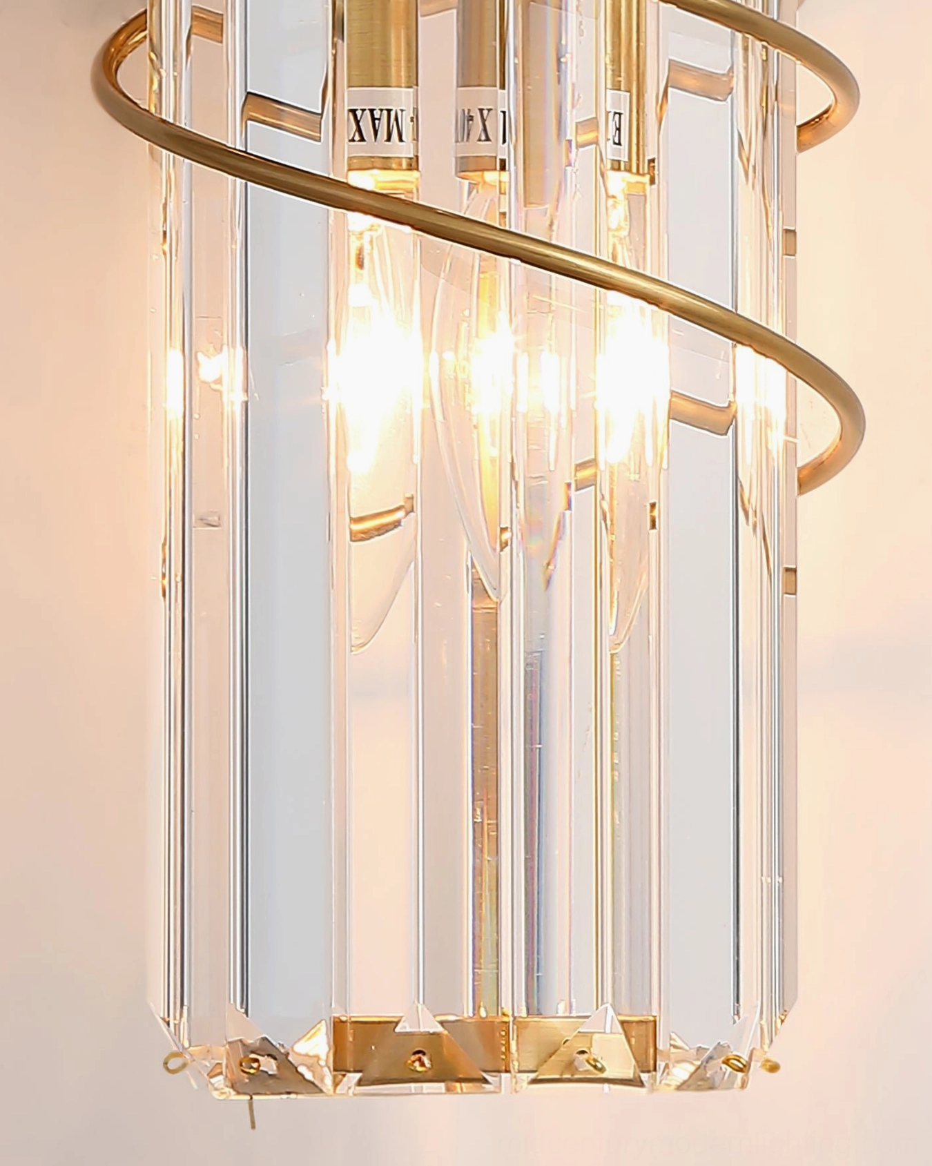 Bonnington crystal wall sconce close-up with visible lit E14 bulbs and brass spiral trim