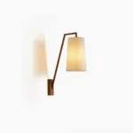 Bonny mid-century modern wall sconce with dark brown metal arm and beige linen shade mounted on neutral wall, front angle view