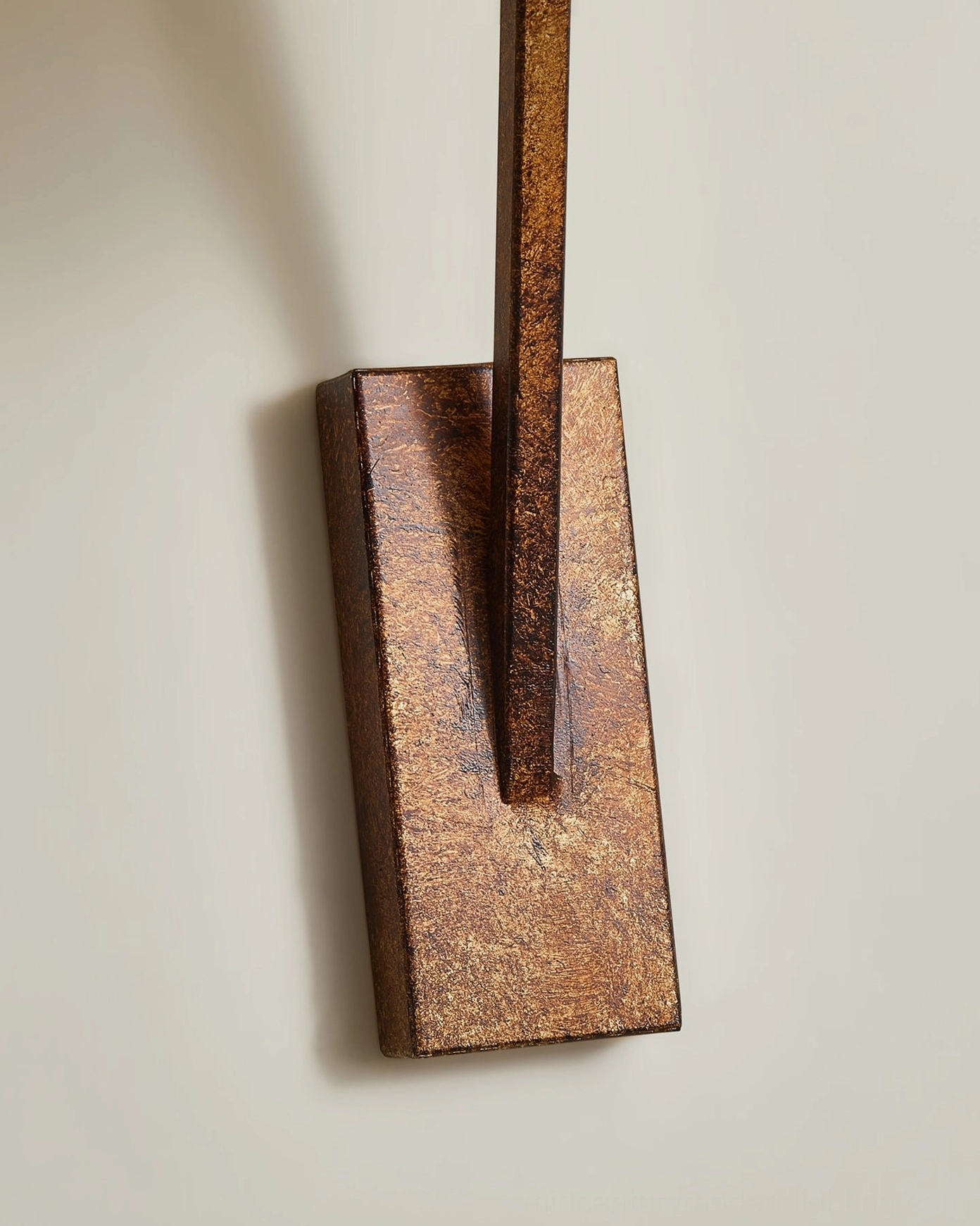 Bonny wall sconce mounting base detail showing rectangular rust-brown textured metal backplate with vertical articulated arm