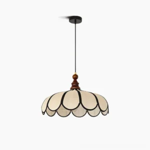 Botan scalloped pendant light with beige abaca fiber shade and black petal trim, walnut wood ceiling cap, studio front view