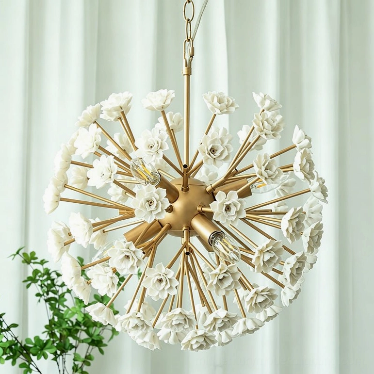 Symmetrical brass gold botanical sputnik chandelier suspended in modern interior with white curtains