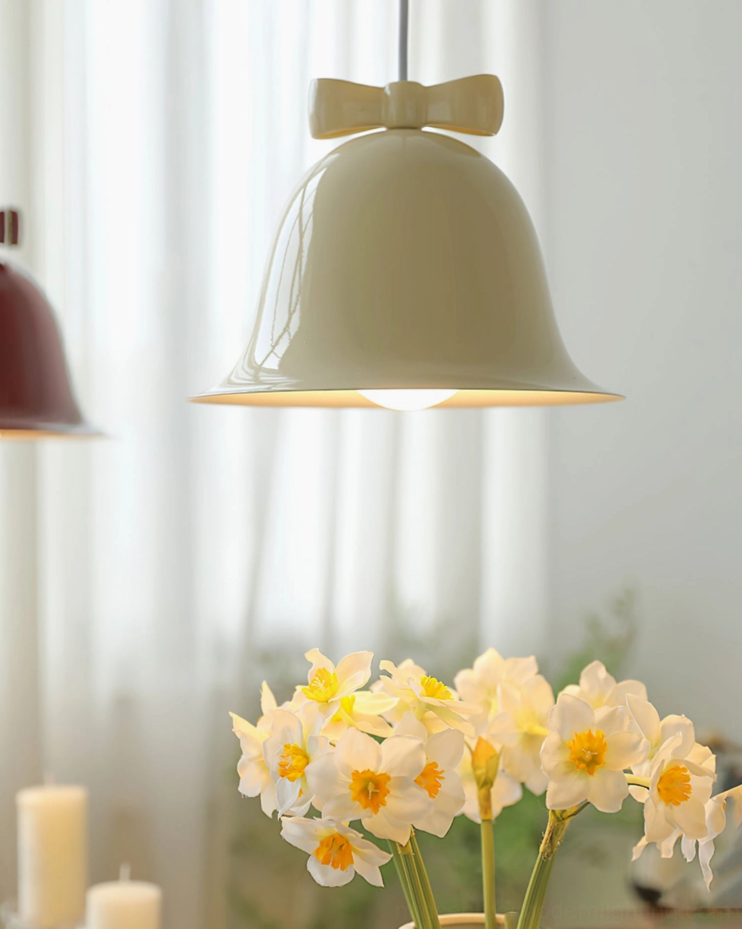 Cream bell pendant lamp with soft bow accent in bright natural daylight home interior