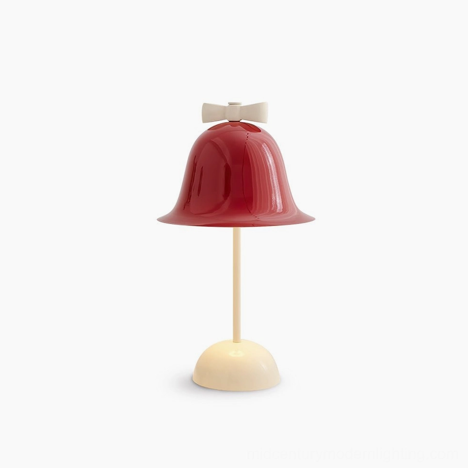 Bow Bell mid-century modern table lamp with burgundy red shade and cream white stand featuring decorative bow detail, front studio view