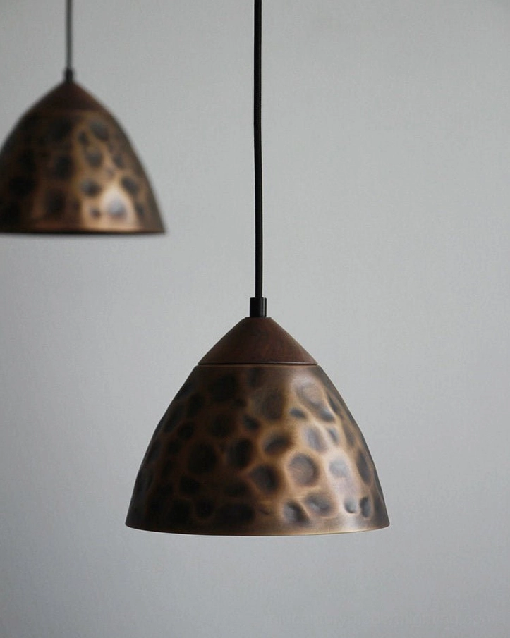 Boyd brass pendant lamp illuminated warm glow overhead view functional ambient lighting design