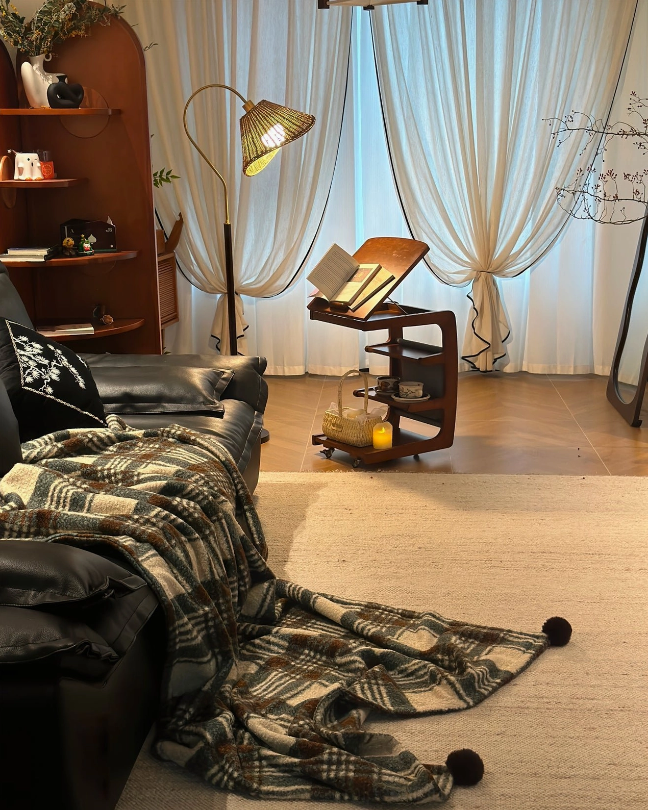 Brady rattan floor lamp lifestyle shot demonstrating cozy ambient light and warm interior atmosphere in contemporary home setting