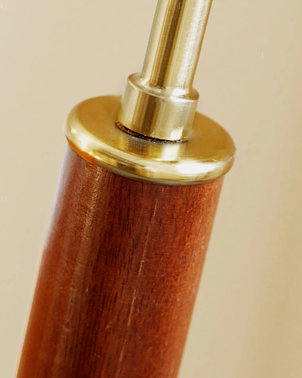 Detailed view of Brady floor lamp brass joint hardware with dark walnut wood pole, mid-century modern metal accents