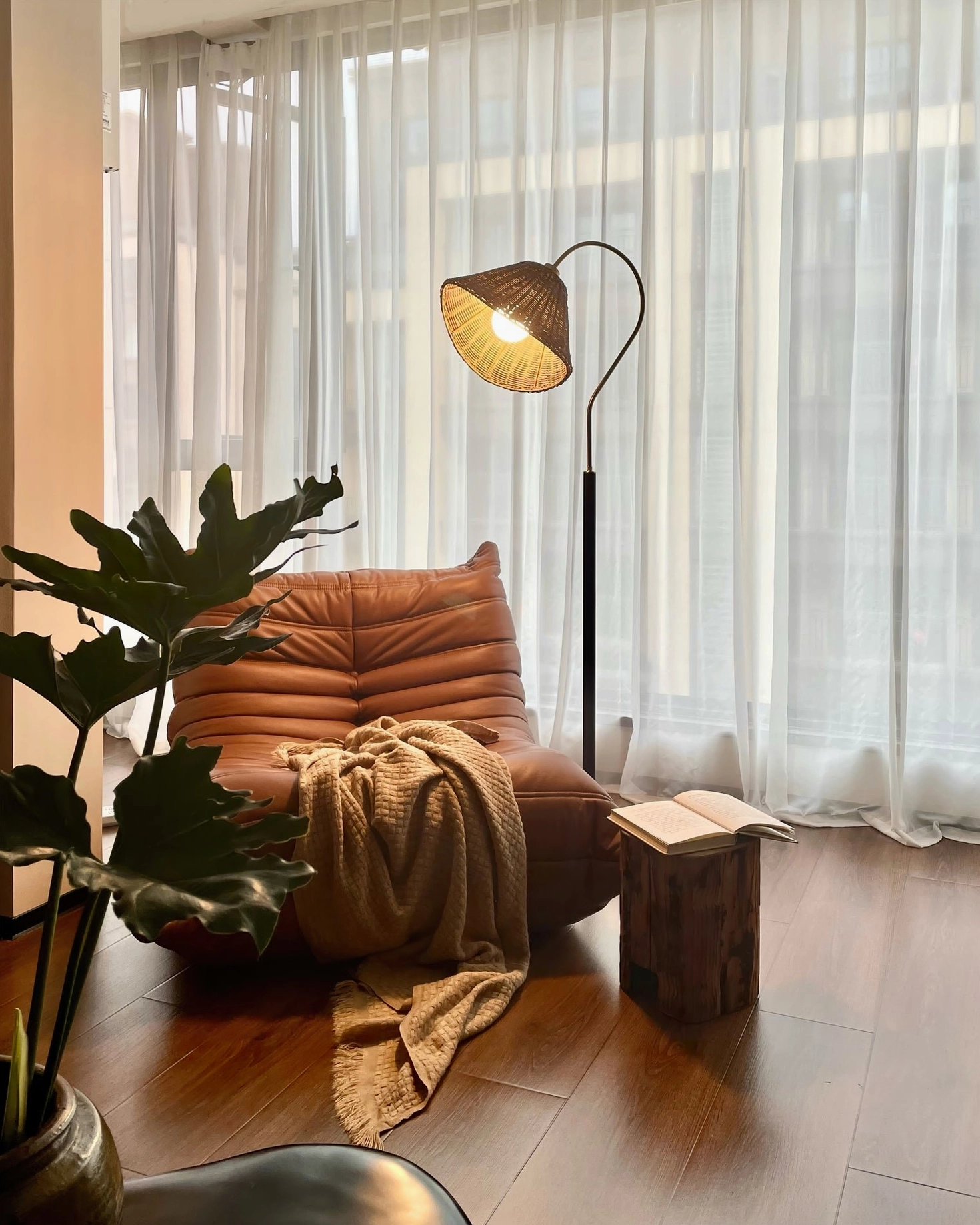 Brady mid-century modern rattan floor lamp full product view showing proportions, warm lighting ambiance, and design silhouette