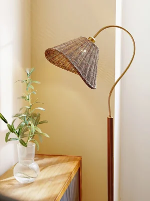Brady floor lamp positioned in living room corner next to warm wooden side table, demonstrating interior styling and ambient lighting