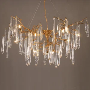 Close-up detail of Branch Raindrop Chandelier showing warm Edison bulbs and delicate crystal rain drop pendants with antique brass framework