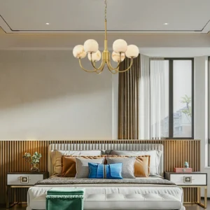 Modern brass alabaster chandelier installed in luxury master bedroom with warm ambient lighting from multiple alabaster globe shades