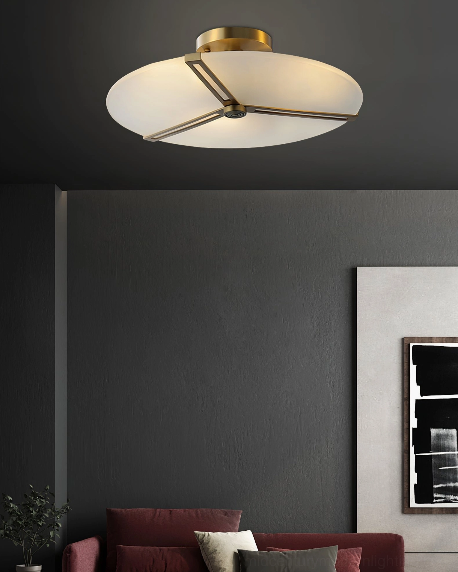Studio photograph of brass ceiling lamp with triangular frame and frosted glass disc