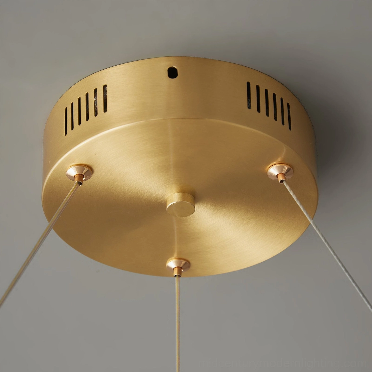 Brass ceiling mount bracket with ventilation slots and modern minimalist design detail