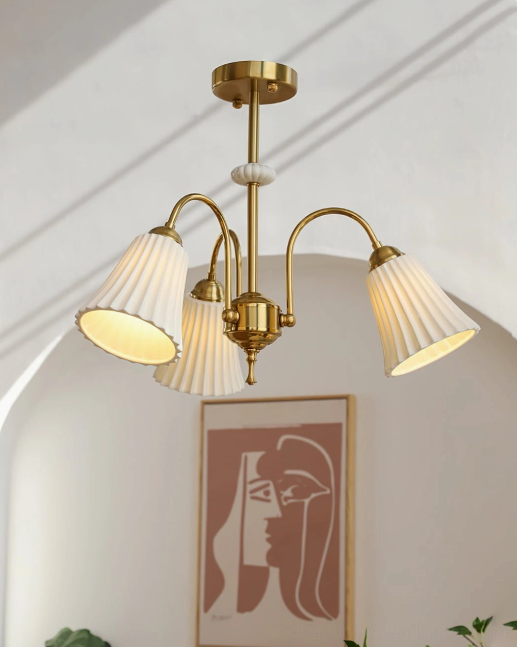 4-head brass pendant chandelier in archway with abstract art print, vintage French design aesthetic, soft warm lighting ambiance