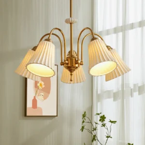 5-head brass chandelier with pleated glass shades installed in French vintage living room with wall art and sheer curtains, warm atmospheric lighting