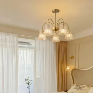 Multi-head brass chandelier with fluted glass shades in french style bedroom interior design