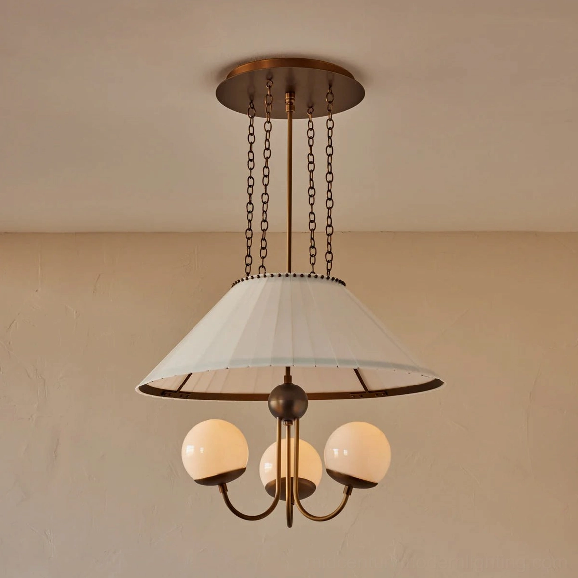 Brass chandelier three globe shade fixture close-up studio photography