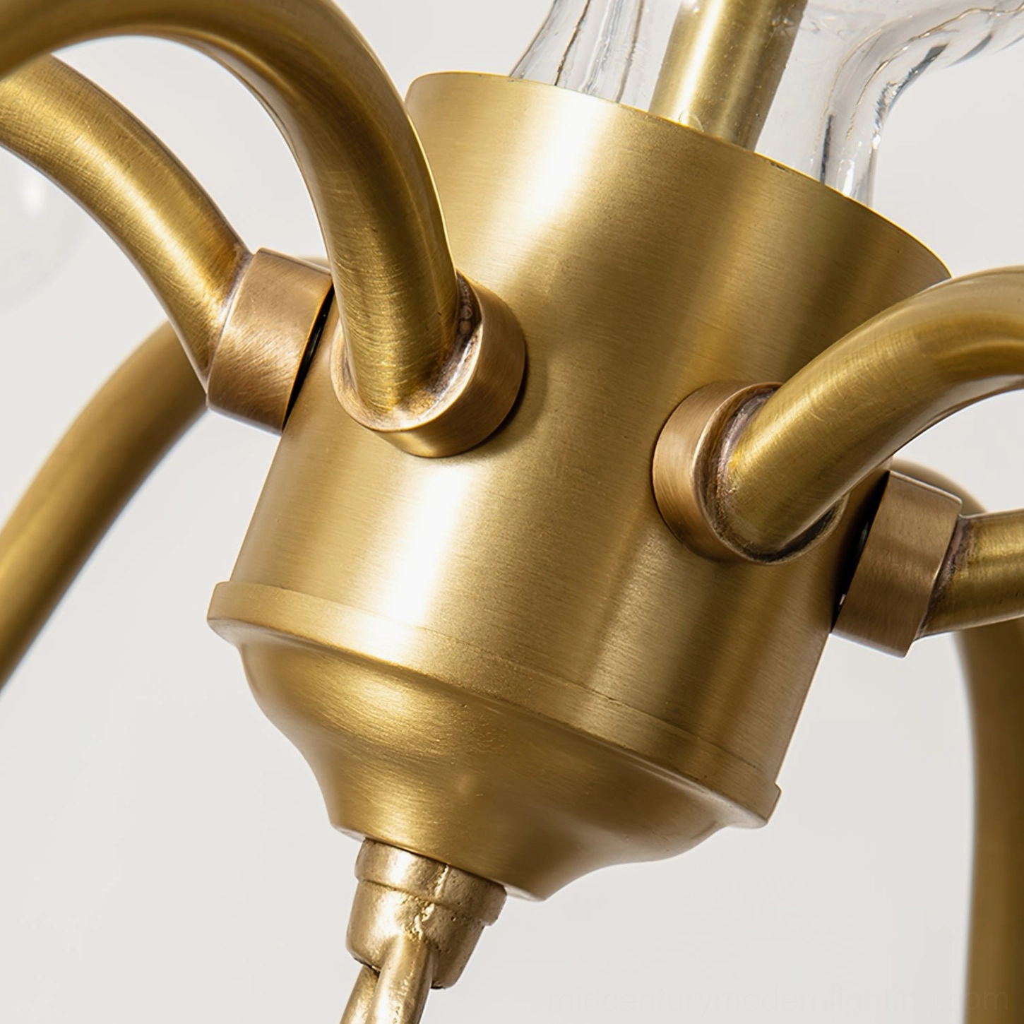 Brass chandelier joint curved arm connection polished metal detail macro photography