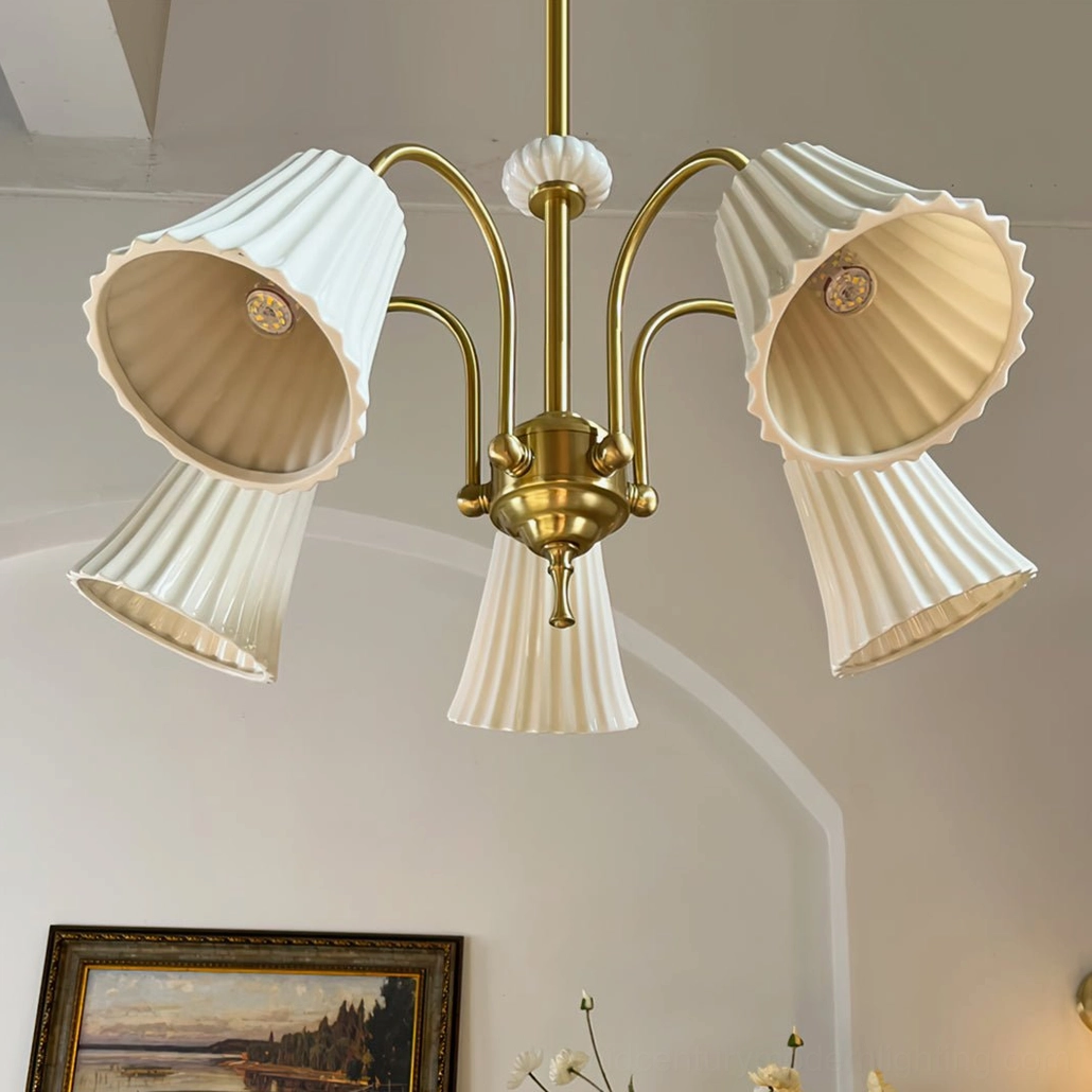 Brass chandelier with multiple pendant heads creating warm ambient lighting in elegant interior space with vintage and modern design elements
