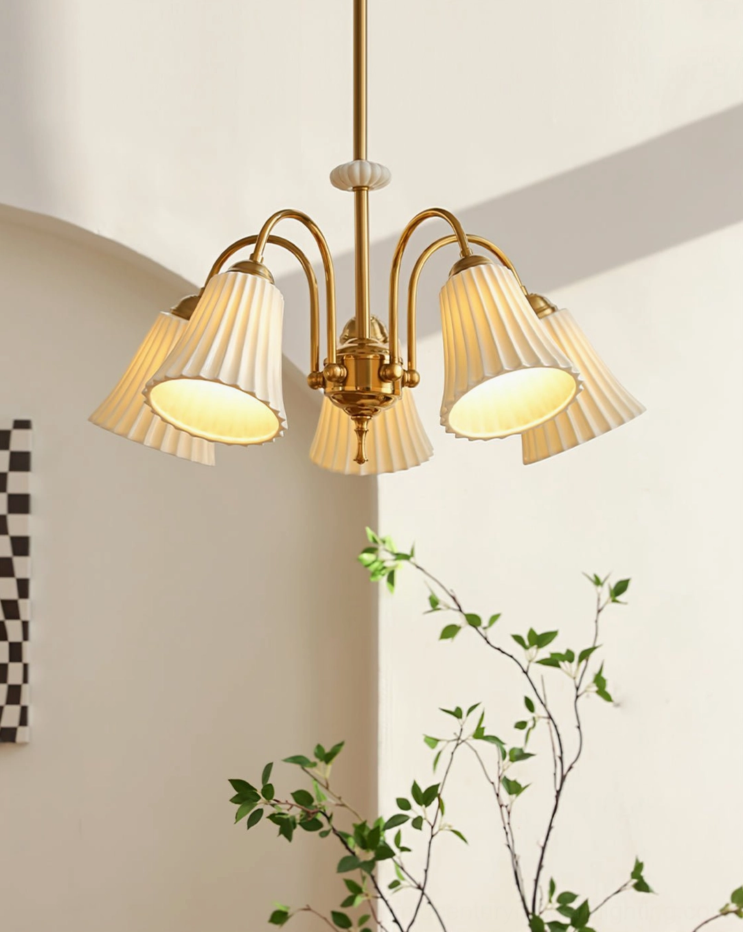 4-head brass chandelier creating warm atmospheric lighting in minimalist Nordic corner with potted green plants, retro mid-century aesthetic
