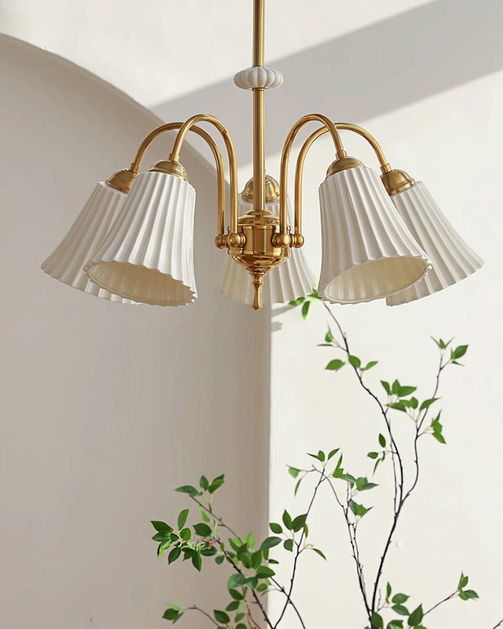 5-head brass pendant chandelier in minimalist Nordic interior with green indoor plants and contemporary corner styling