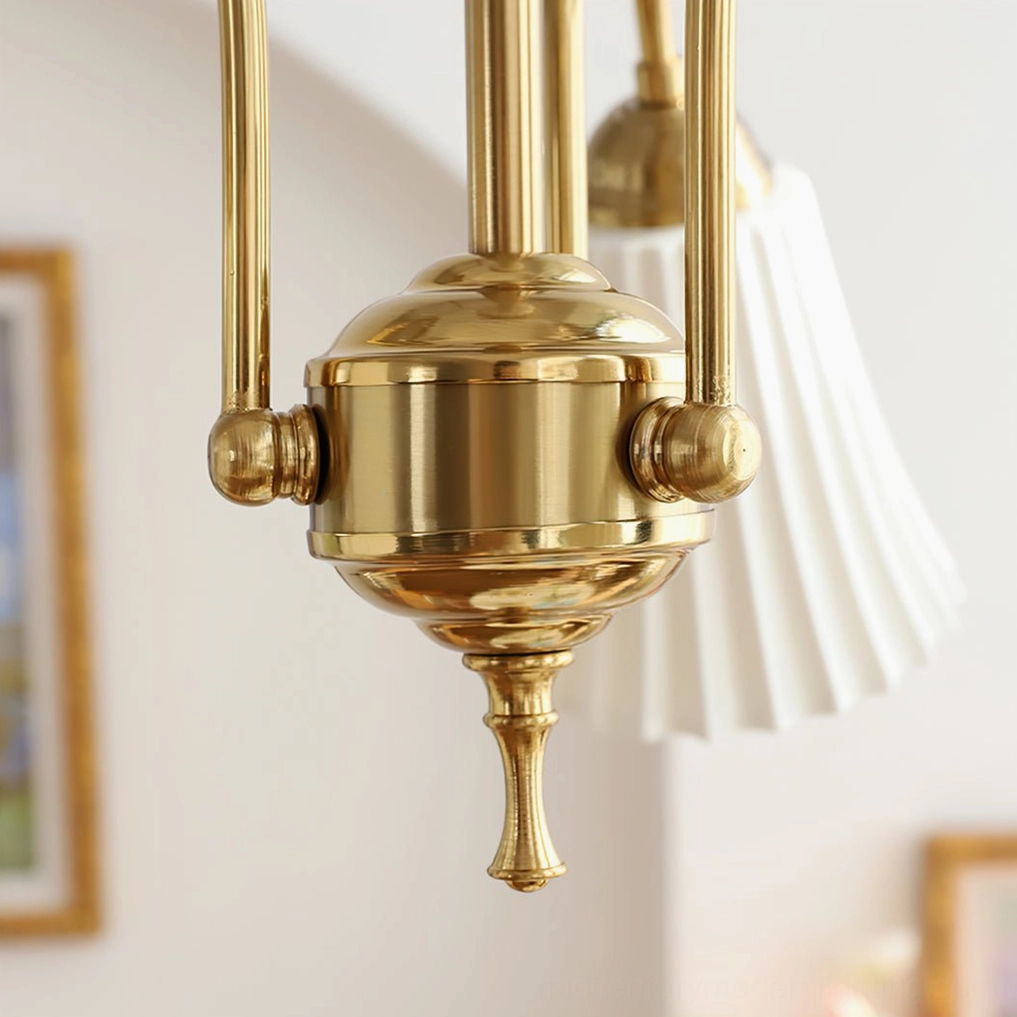 Close-up of pleated white glass shade on brass chandelier, demonstrating light diffusion and classic mid-century modern ribbed glass design