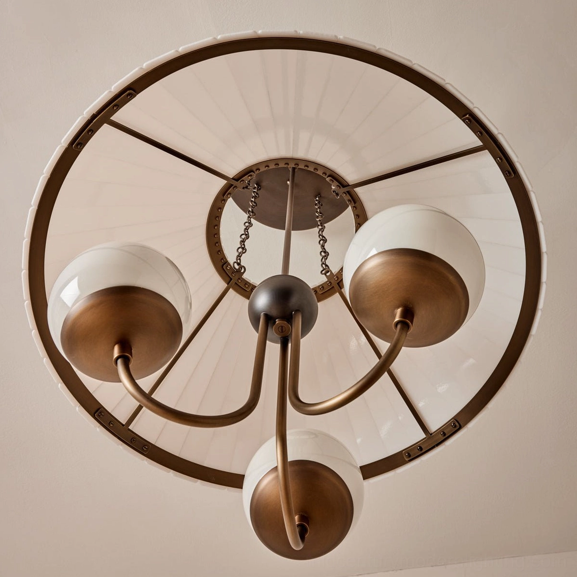Pleated acrylic shade brass chandelier light diffusion close-up