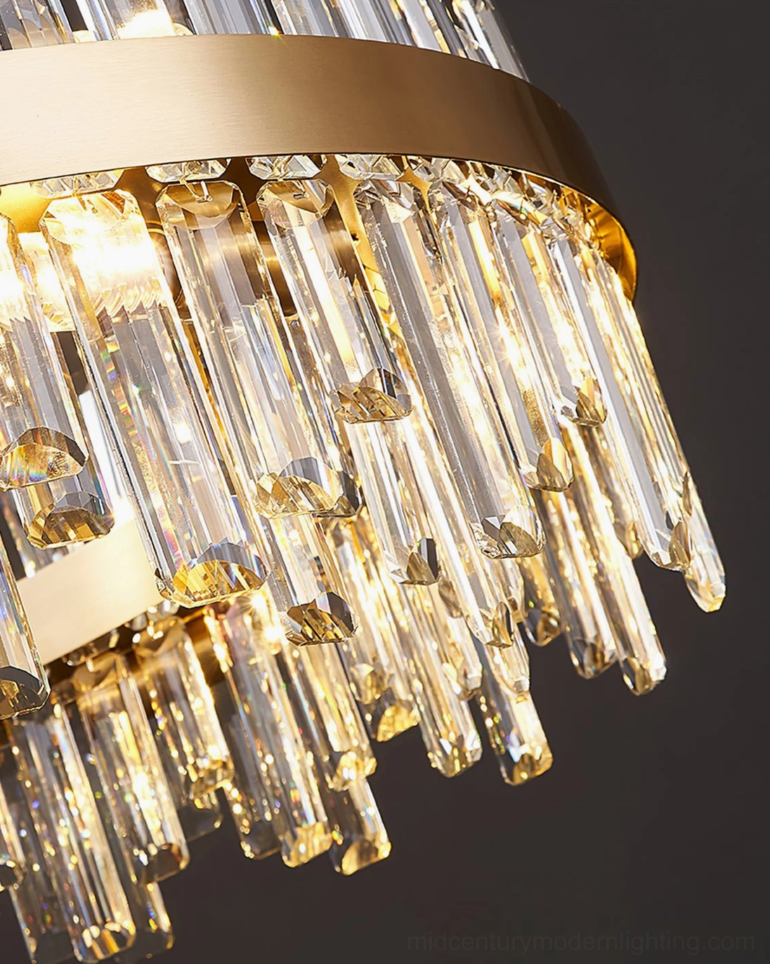 Brass crystal statement chandelier producing warm ambient light in sophisticated interior space