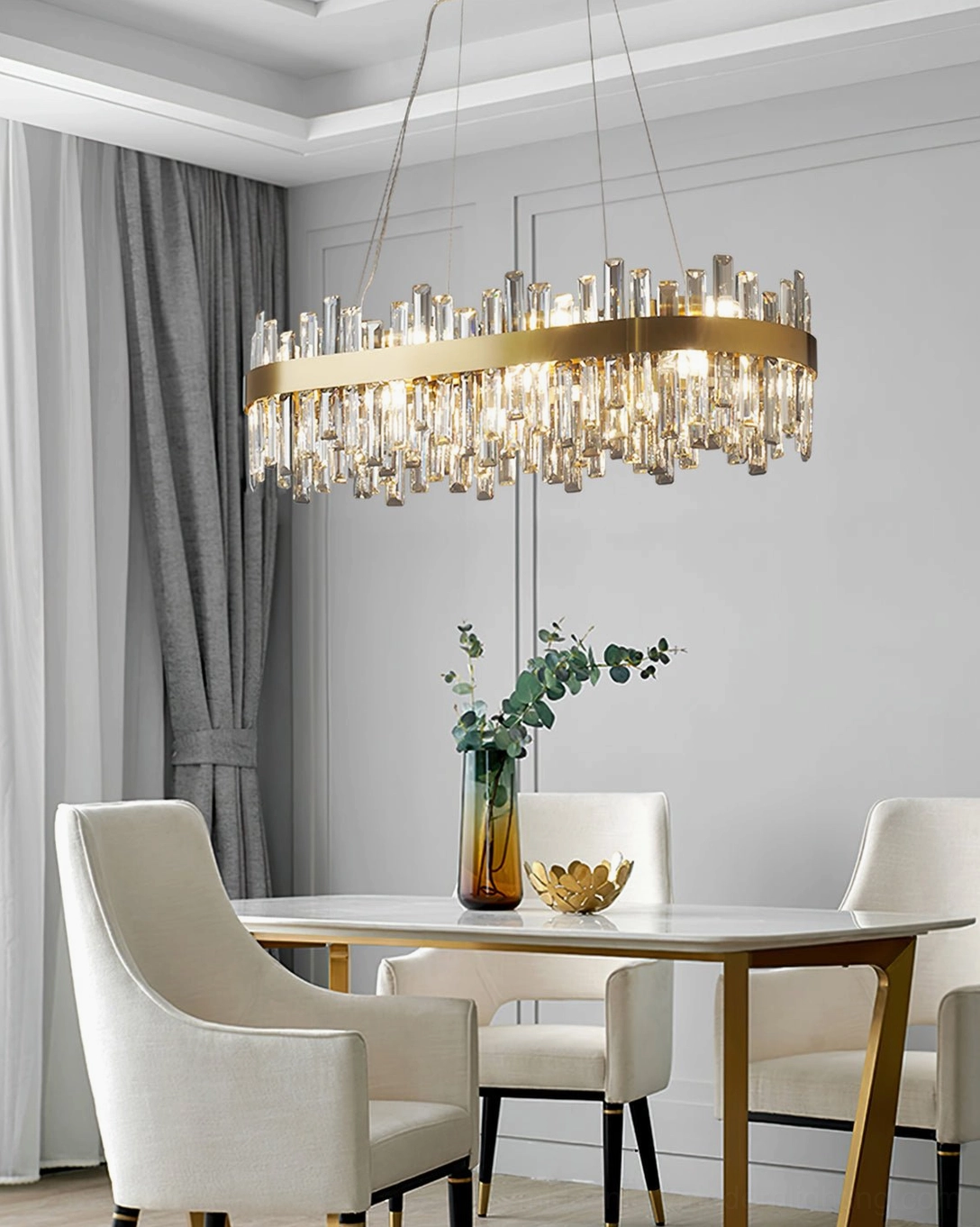 Brass crystal chandelier illuminated in contemporary interior space showing light refraction through crystals