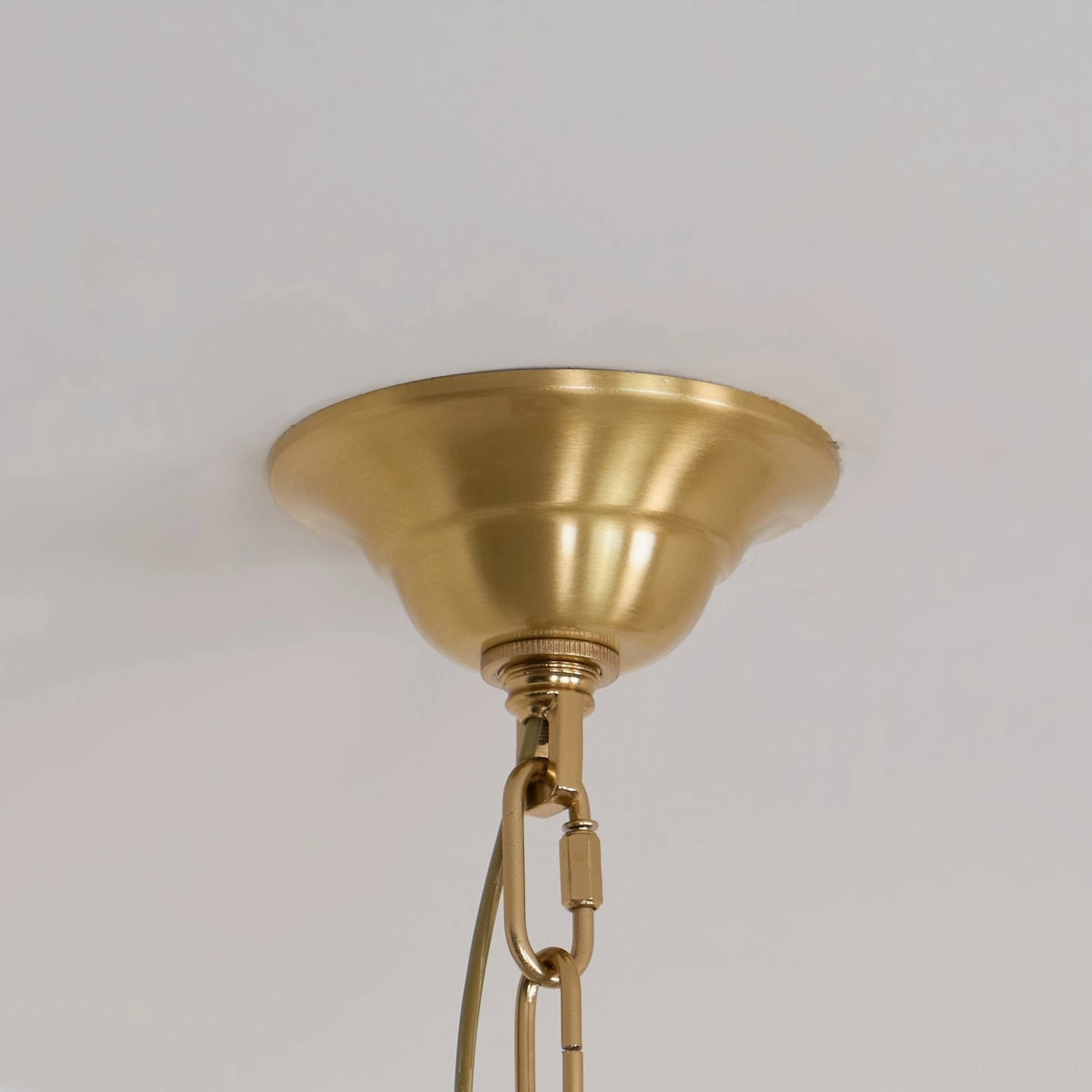 Elegant brass chandelier with crystal glass beads creating luxurious light refraction in modern home