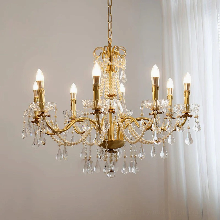 Illuminated brass crystal chandelier suspended indoors, lit candles showcasing warm glow and baroque-style crystal cascades