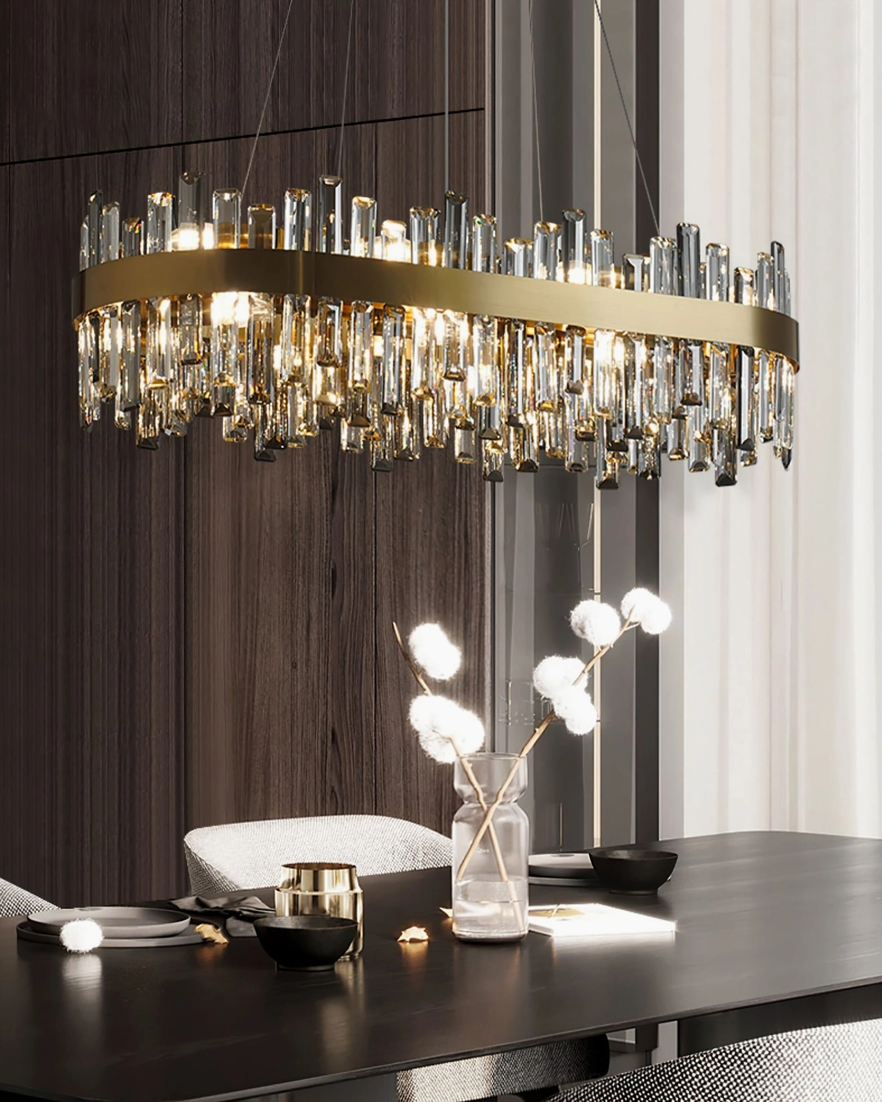 Brass and crystal chandelier in luxury modern dining area with decorative wall ornaments and gold metal accents