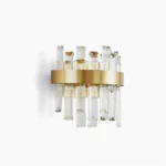Brass crystal wall sconce with dual E14 sockets and cascading opaque crystal rods, studio front view showing geometric modern design