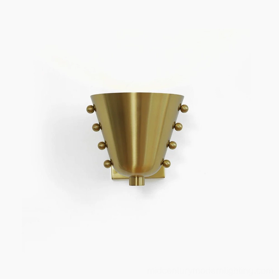 Brass gold geometric wall sconce front view with conical tapered shade and spherical stud details on white background