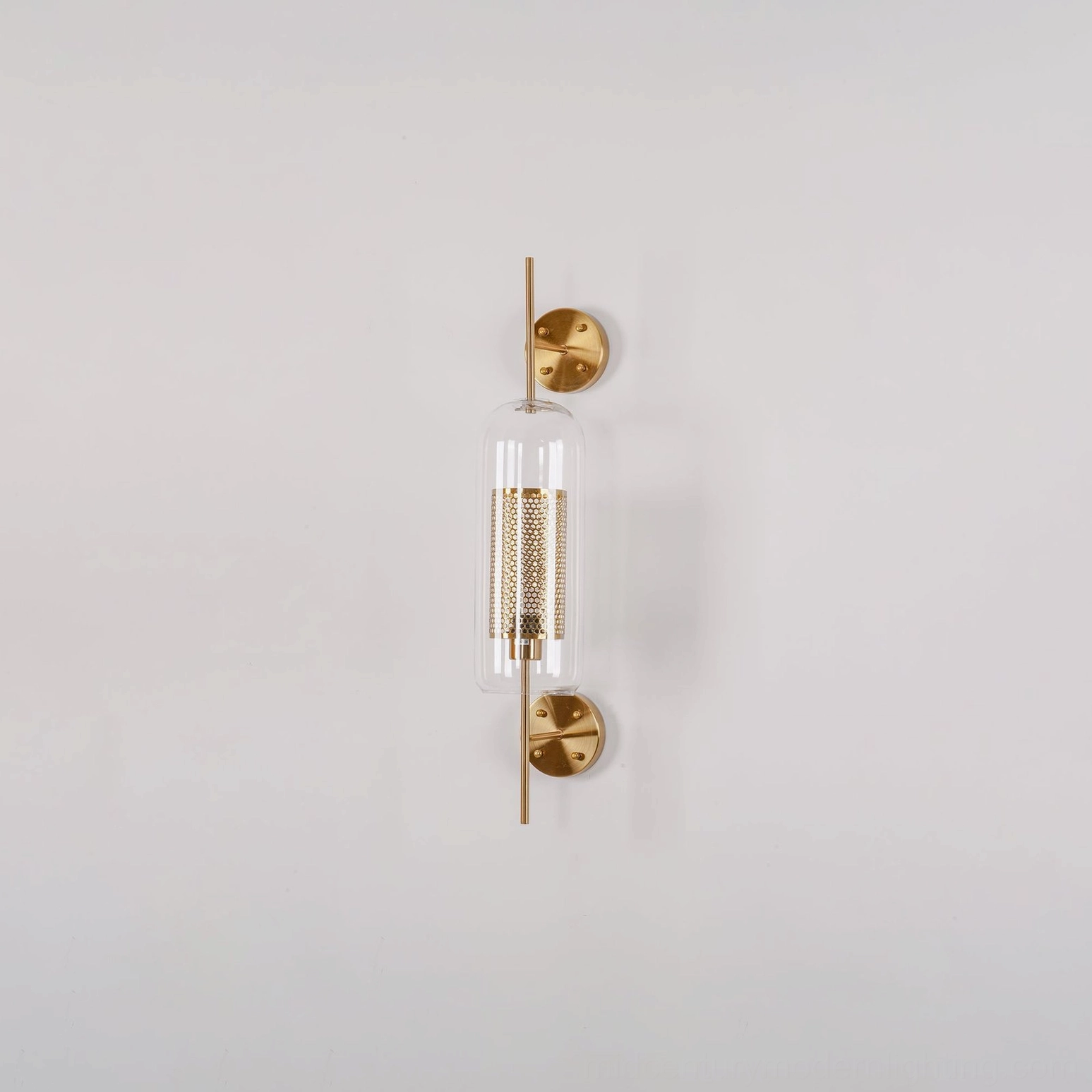 Glass wall lamp with brass hardware in modern minimalist interior setting