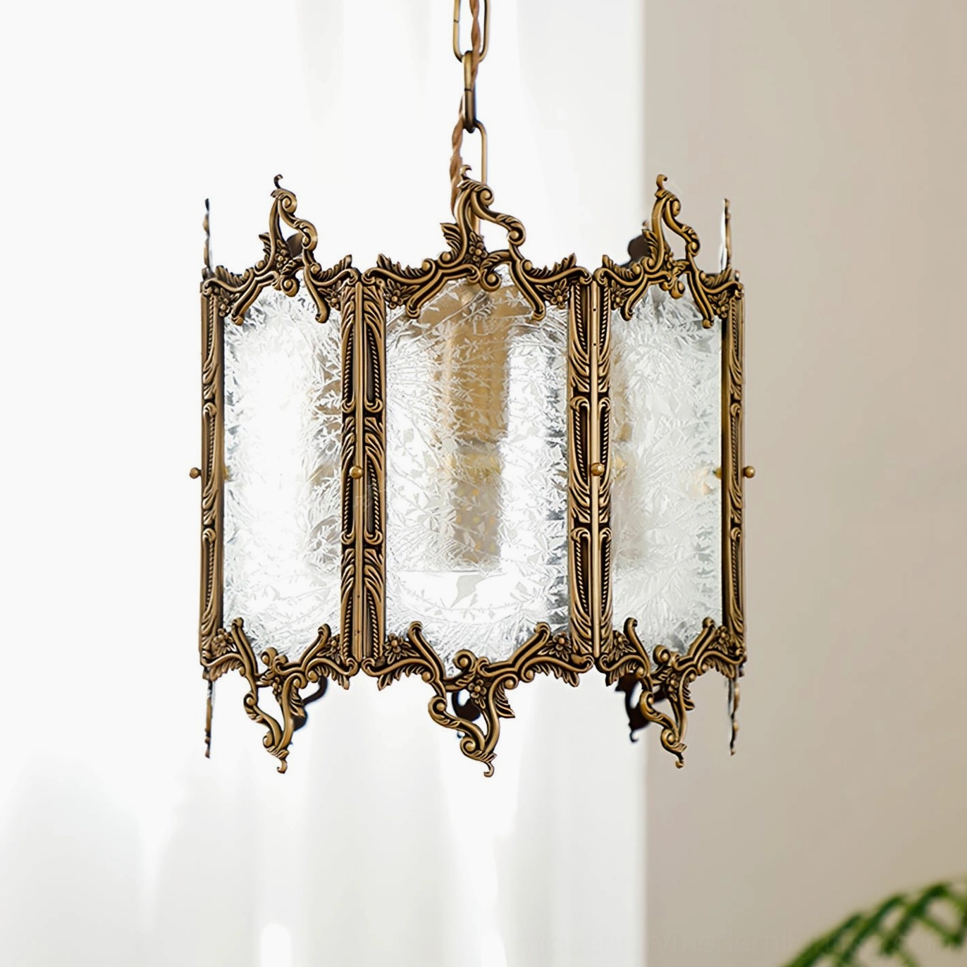 Brass glass lantern pendant hanging fixture in elegant home interior with neutral tones and modern minimalist design aesthetic