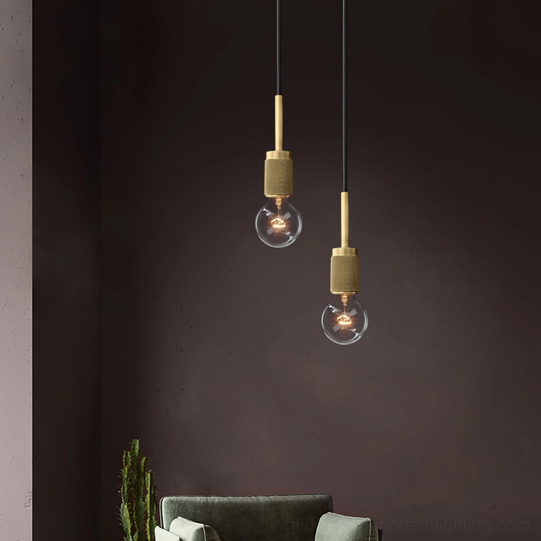 Two single brass pendant lights with glass shades in minimalist living room