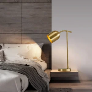 Brass gooseneck table lamp positioned on dark wood nightstand in modern bedroom setting - side profile lighting view