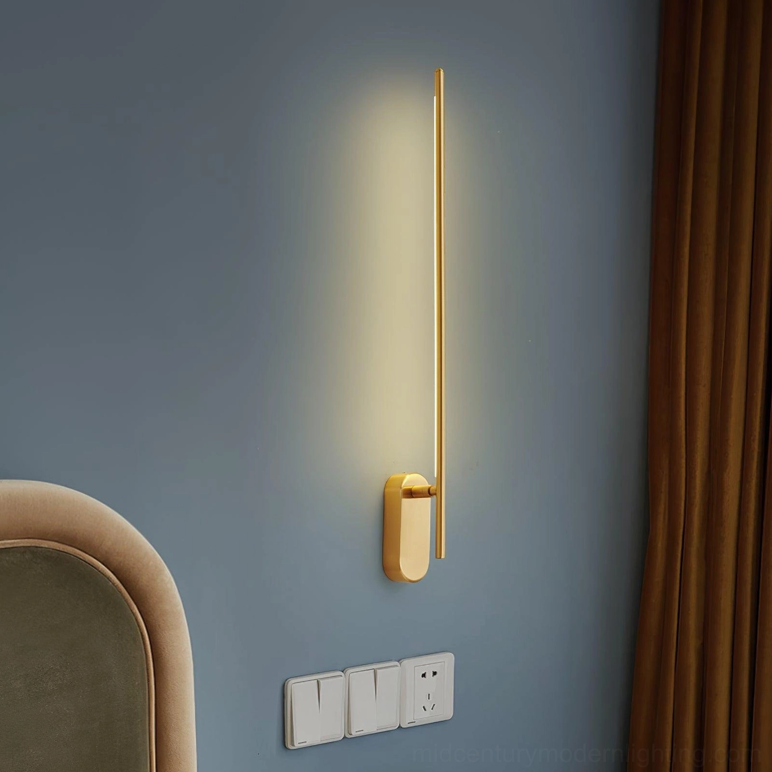 Brass linear sconce blue accent wall modern warm lighting