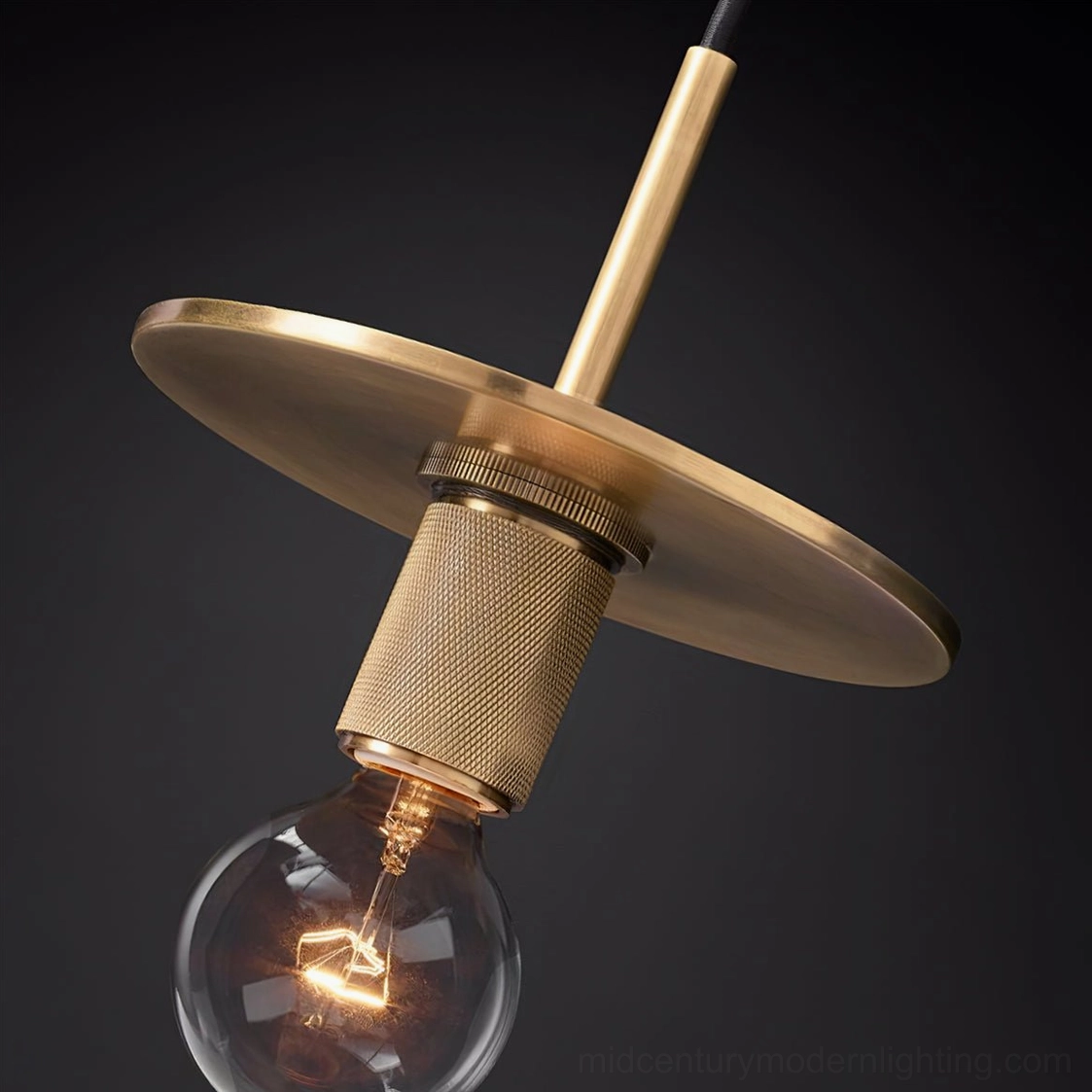 Close-up overhead view of brass pendant lamp with exposed Edison bulb filament