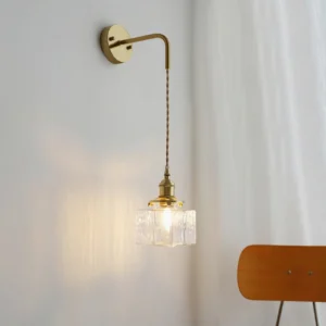 Vintage brass pendant wall lamp with cylindrical textured glass in minimalist bedroom setting